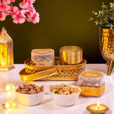 Diwali Gift Hamper featuring roasted almonds, cashews, metallic candle, and gold tray. Perfect for festive gifting and celebrations.